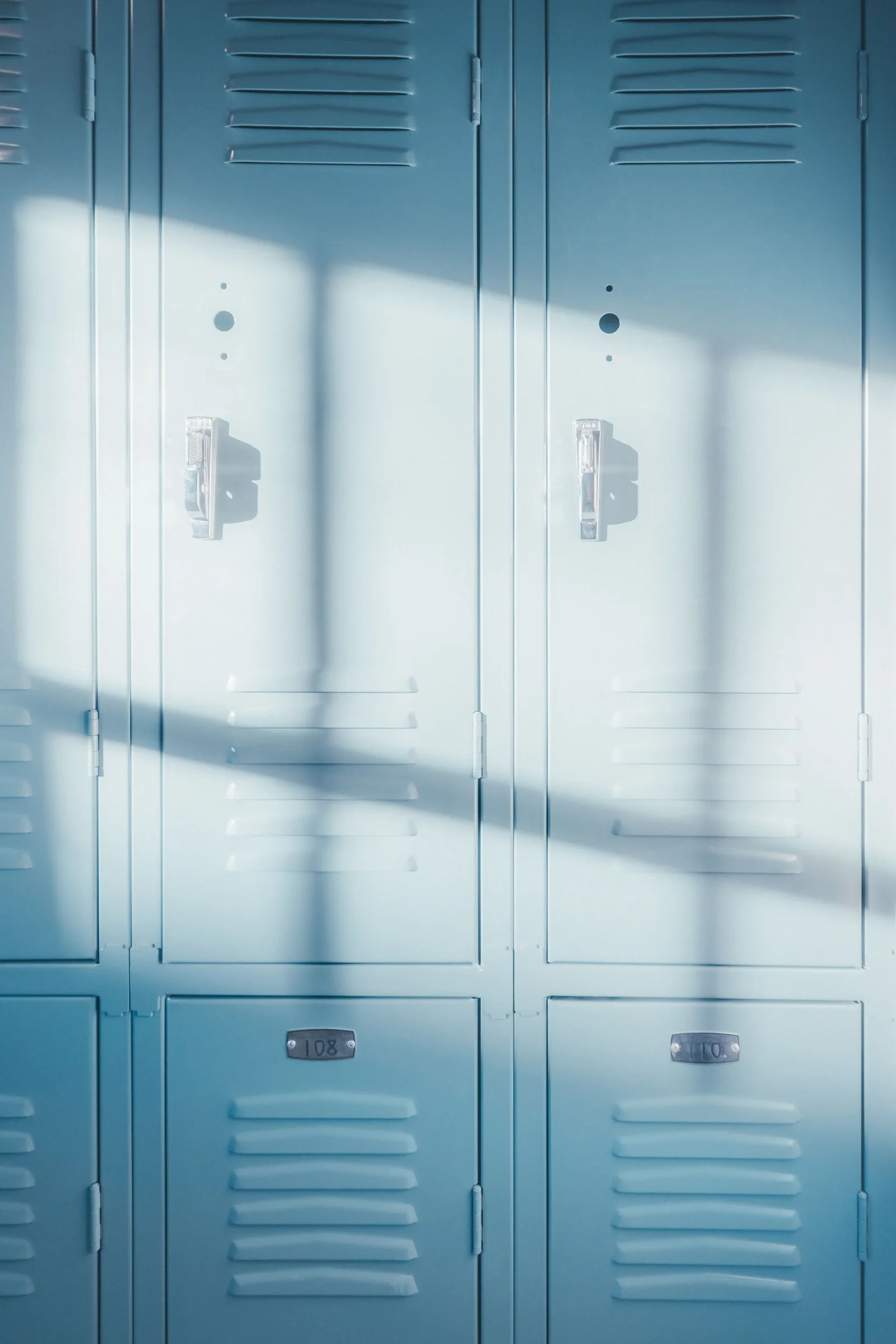 Row of blue school lockers along a clean campus corridor