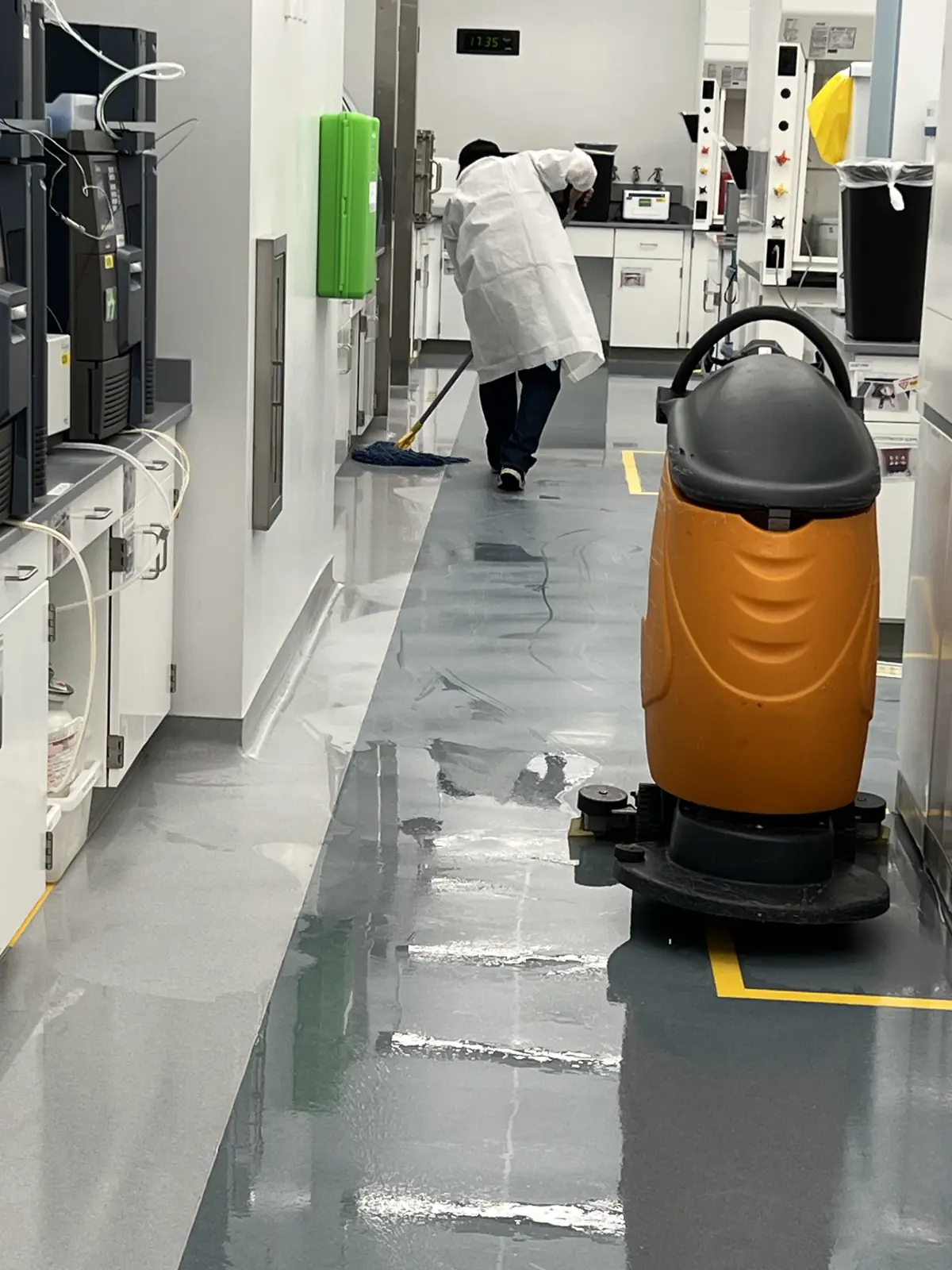 Auto-scrubber cleaning a laboratory floor