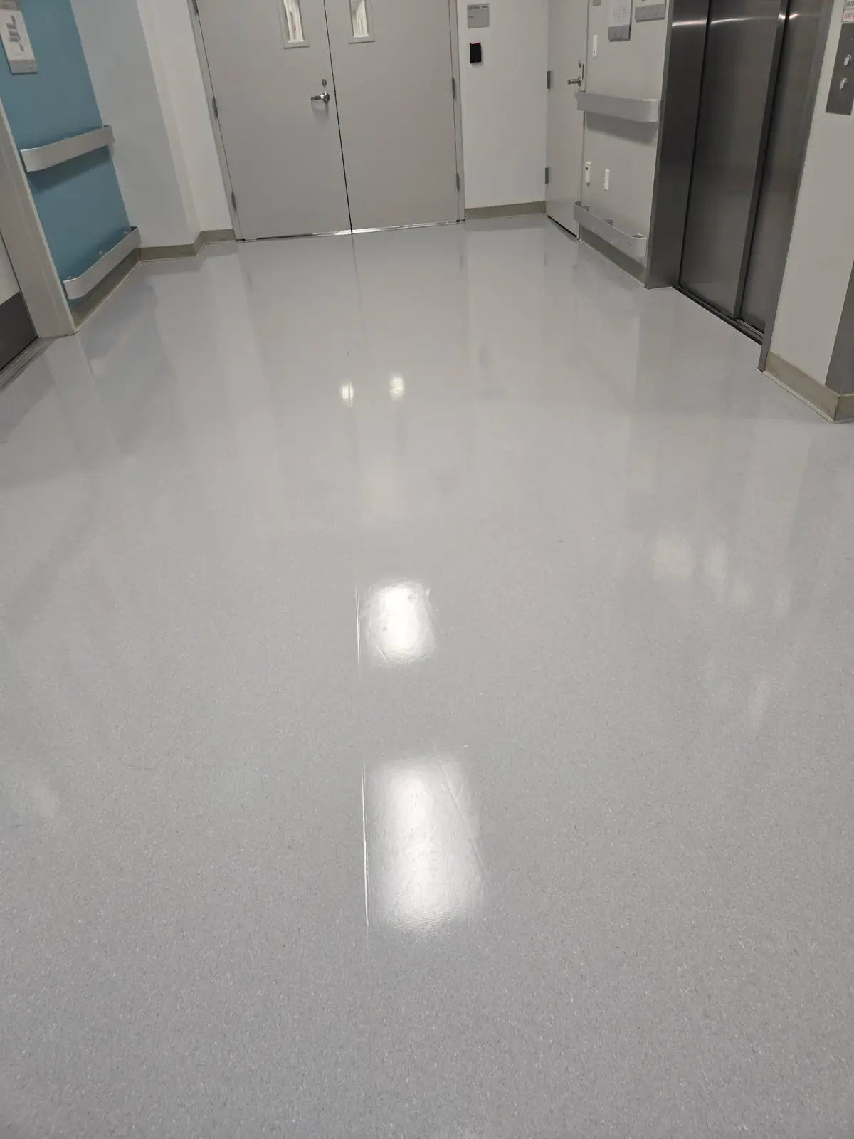 Glossy refinished corridor floor outside laboratory doors