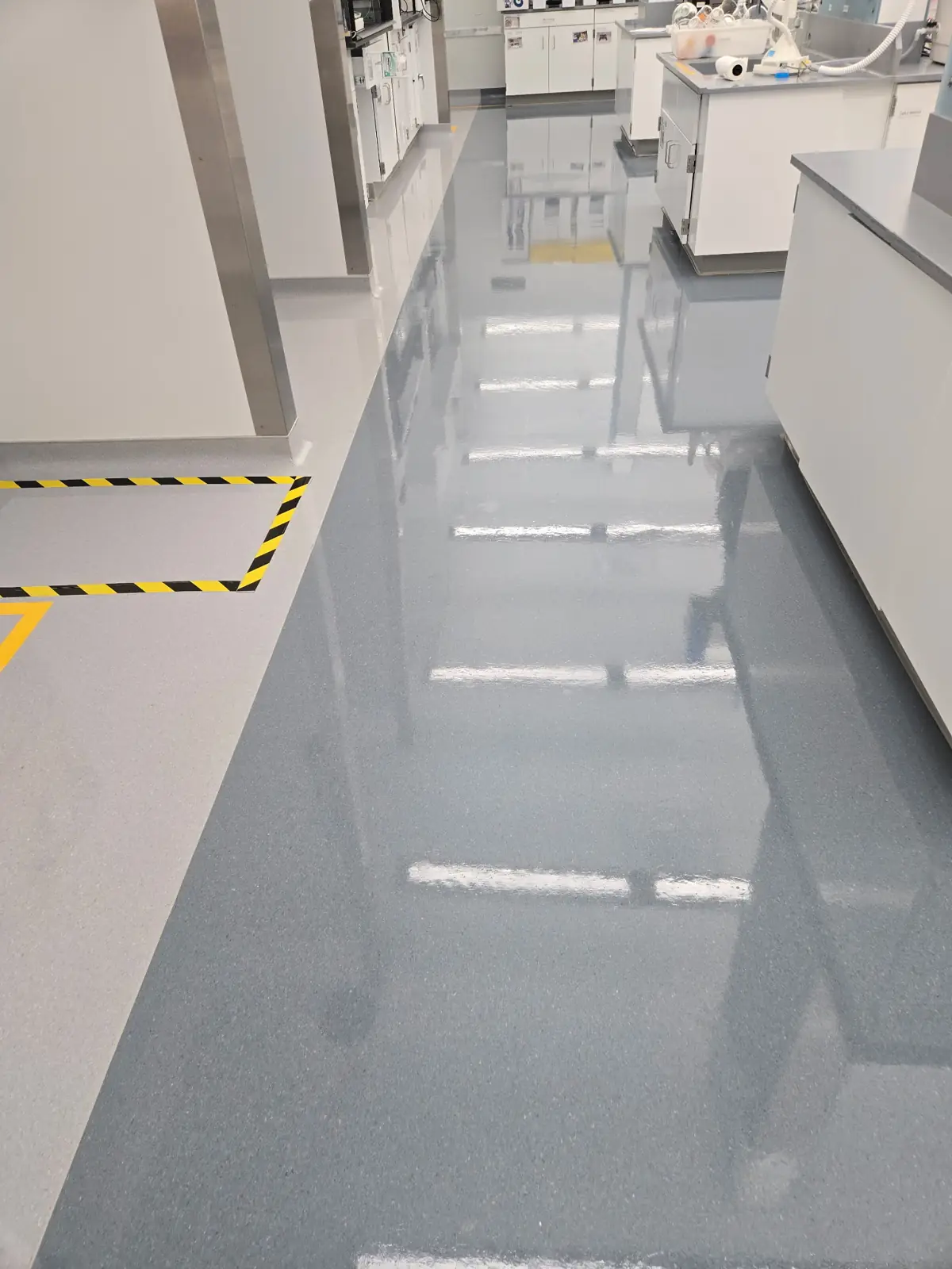Refinished laboratory corridor floor with safety striping