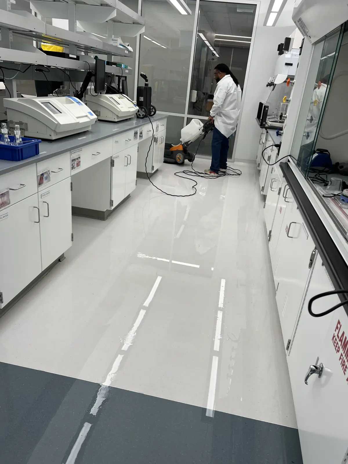Crew stripping a laboratory floor finish