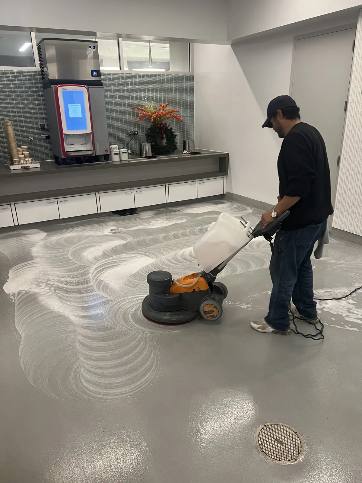 Crew member burnishing a laboratory floor