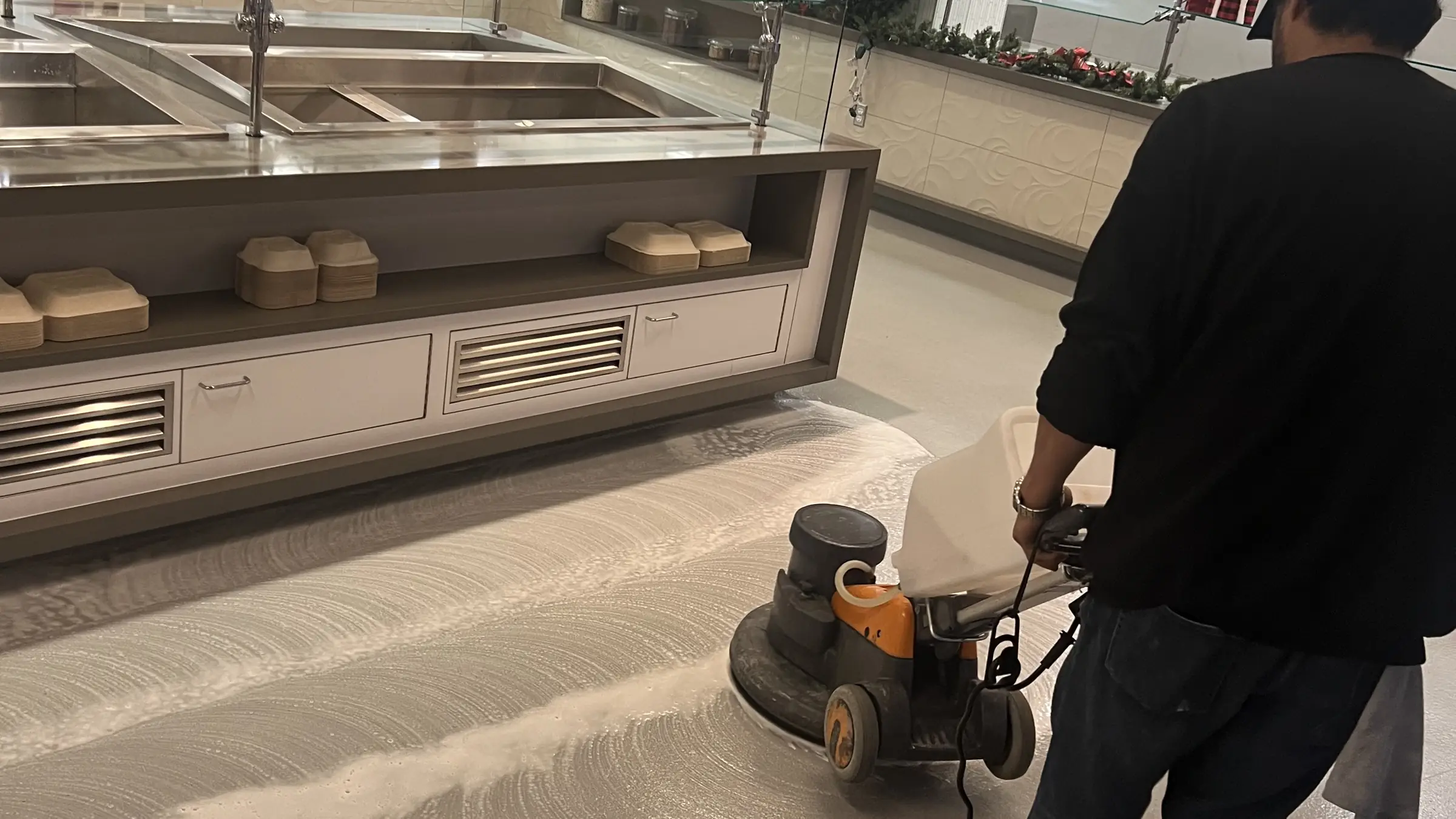 Nexara crew member burnishing a commercial cafeteria floor